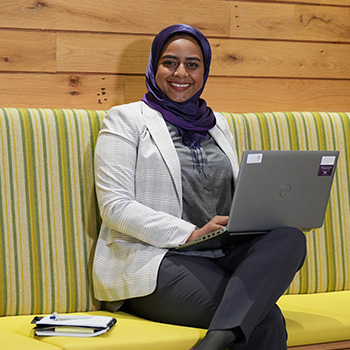 Alaa Ibrahim sitting and working on laptop