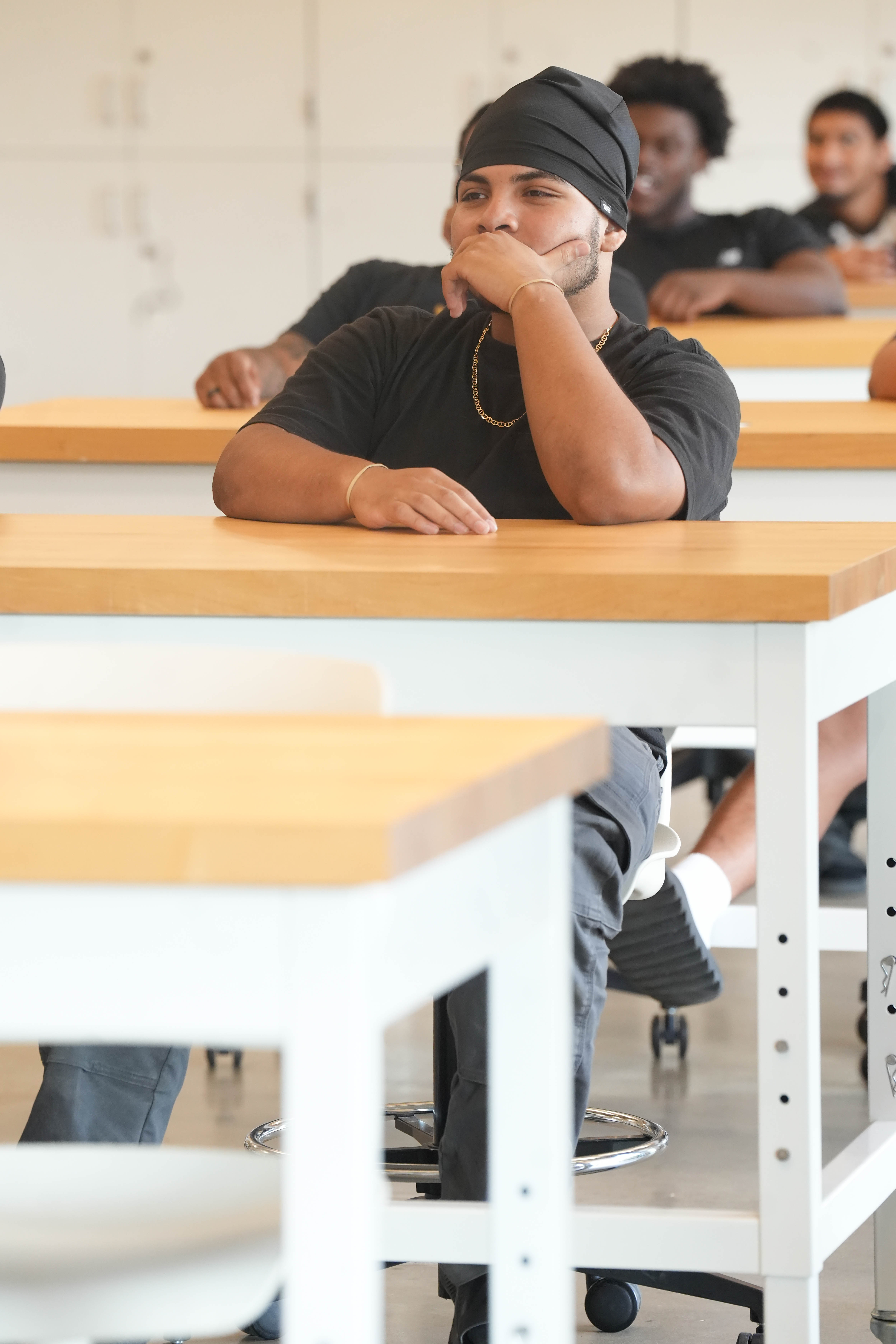 Participant sits at a desk with his attention toward the front of the room