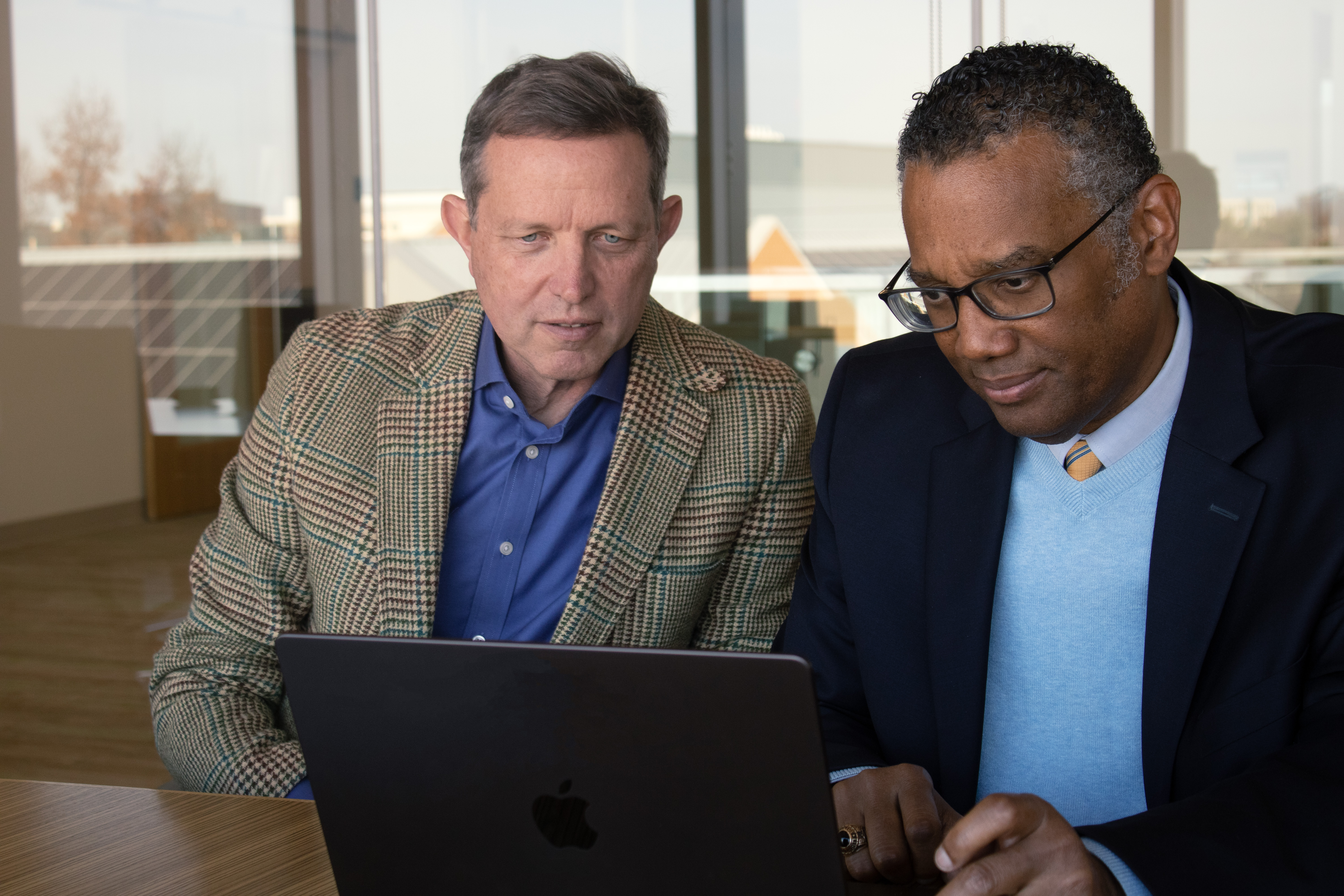 Dr. Joe Bailey and Dr. Hank Boyd working together behind a laptop.