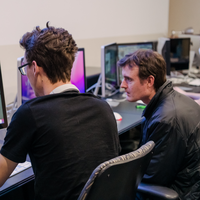 Two people looking at a computer screen together