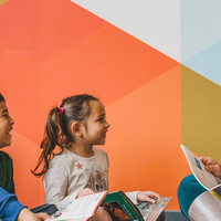 Teacher reading to two children