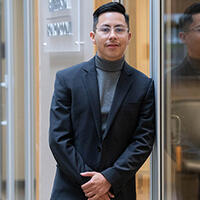 Brian Argueta standing outside conference room