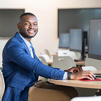 Exaucé Kabamba at a computer