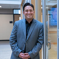 Juan Paredes standing outside conference room
