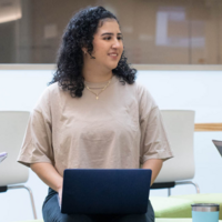 3 female students on laptops