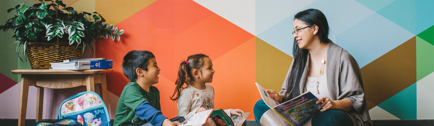 Teacher reading to two children