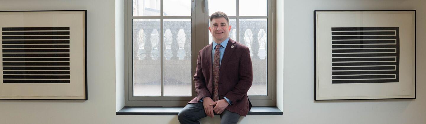 Justin Barclay sitting on window
