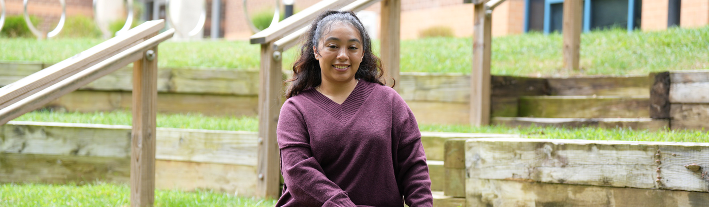 Liliana Escalante Mena sitting outside on USG campus