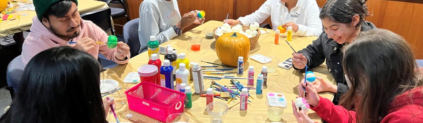 Students painting at the Student Leadership and Advisory Council's Fall Fest