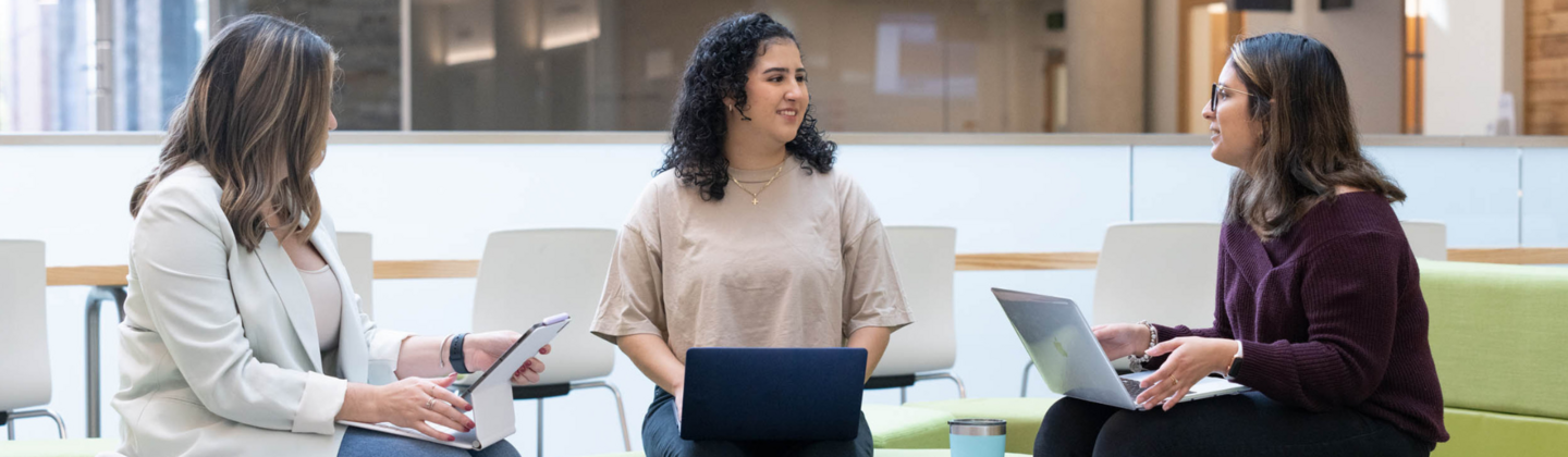 3 female students on laptops