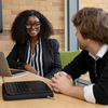 Students in professional clothing talking in a conference room
