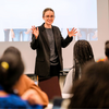 Person at the front of a classroom giving a presentation